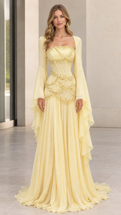 Front view of pastel yellow square neck beaded corset evening gown with dramatic bell sleeves