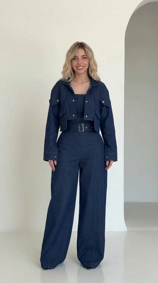 Front full view of woman wearing navy blue cropped utility jacket and matching belted wide-leg trousers