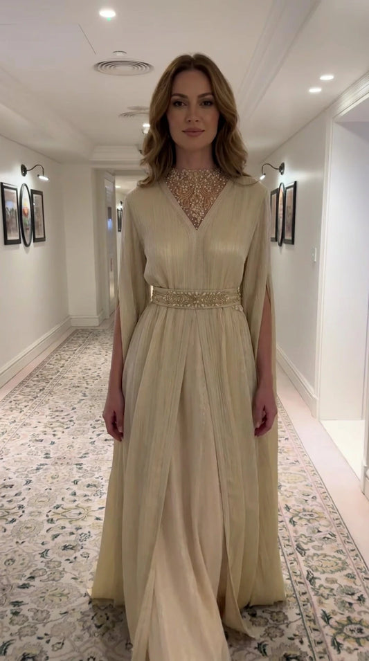 Full front view of Champagne Gold embellished illusion neckline pleated cape evening gown