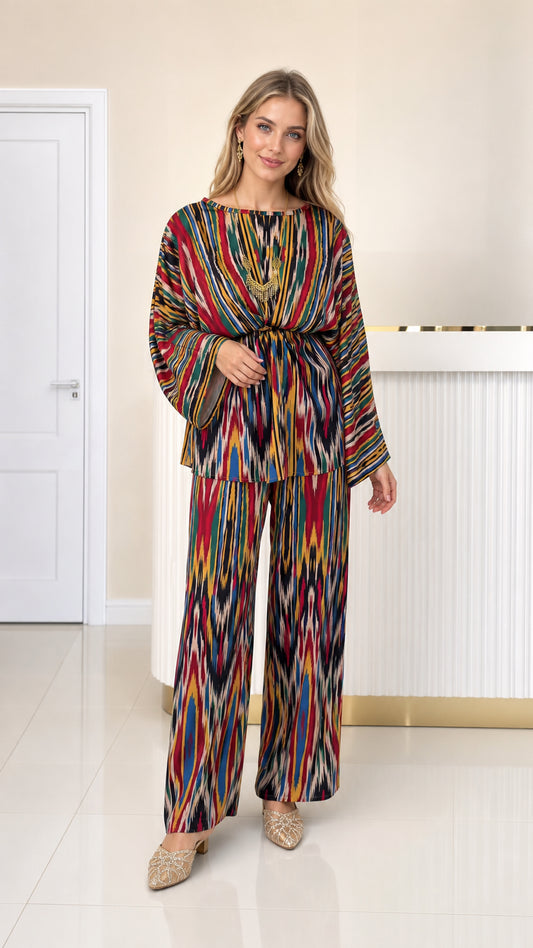 Front full view of woman wearing multicolor ikat print pleated top and wide leg pants set