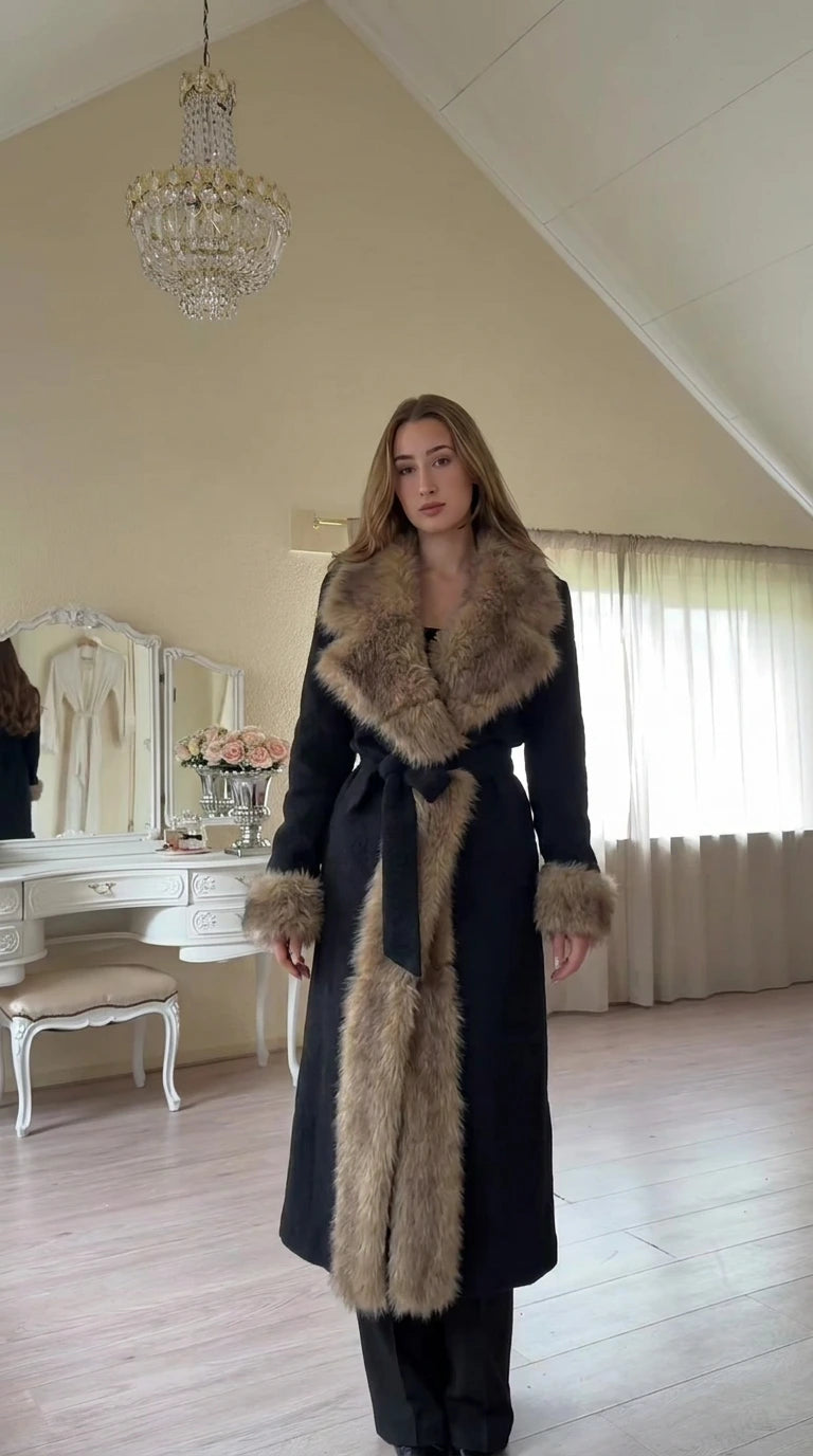 Front view of model wearing full-length Black faux fur trim belted coat