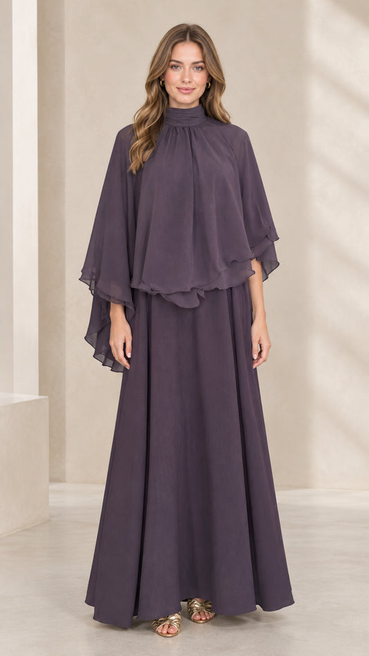 Front view of woman wearing dusty plum mock neck capelet maxi dress