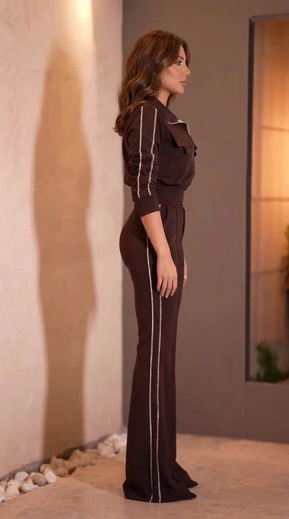 Side profile view of woman wearing chocolate brown flare jumpsuit with contrast stripe