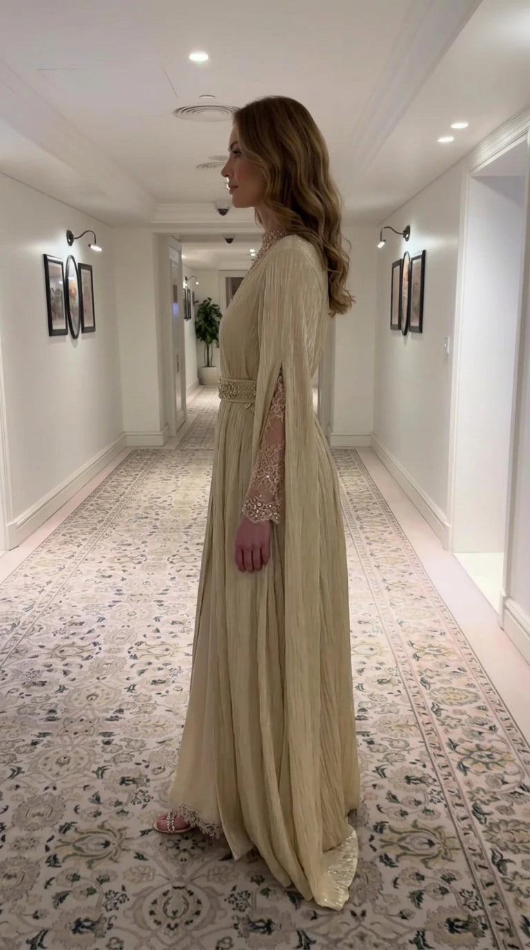 Side profile view of Champagne Gold pleated maxi dress showing split cape sleeves