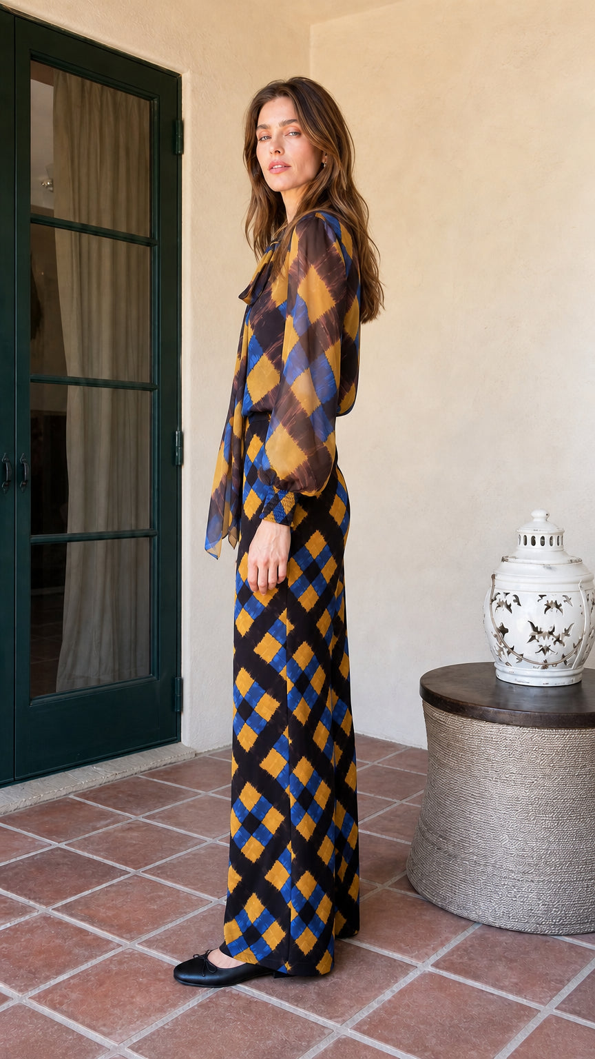 Side profile view of model in mustard and blue plaid matching set