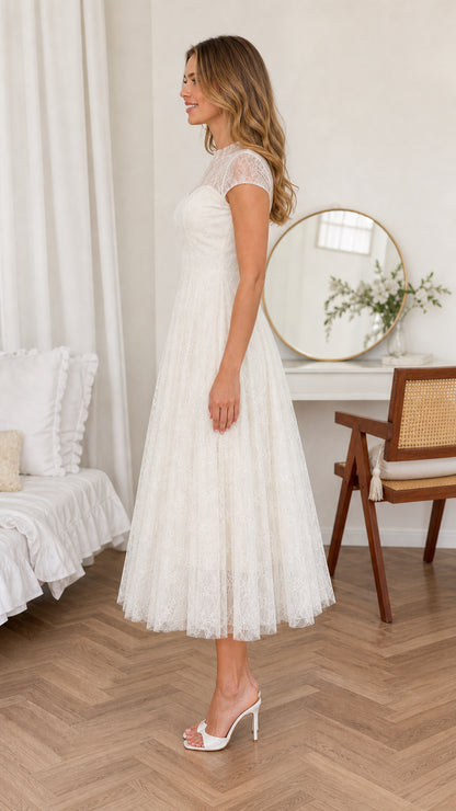 Side profile view of woman wearing Ivory White cap sleeve lace midi dress