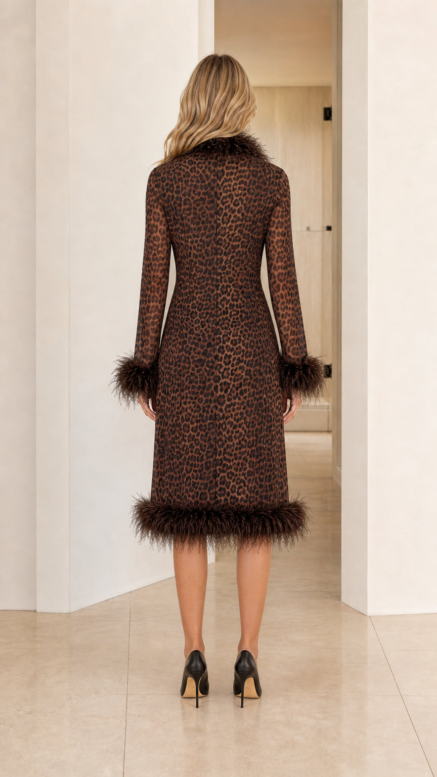 Back view of model in the brown leopard midi coat showing hem and cuff trim details