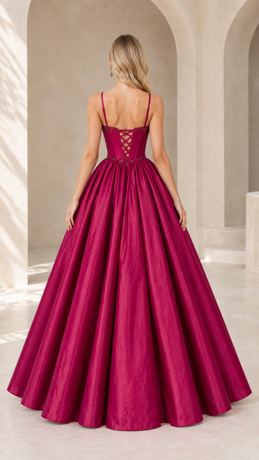 Back view of magenta formal gown showing lace-up corset detail and full skirt