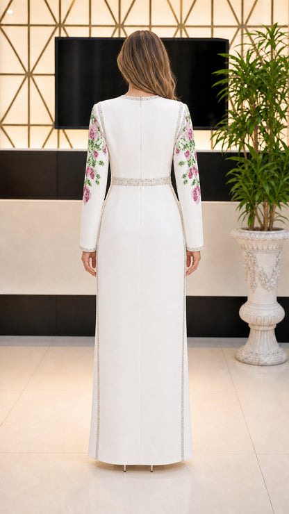 Back view of white long sleeve column maxi dress with embroidered sleeves and waist detail