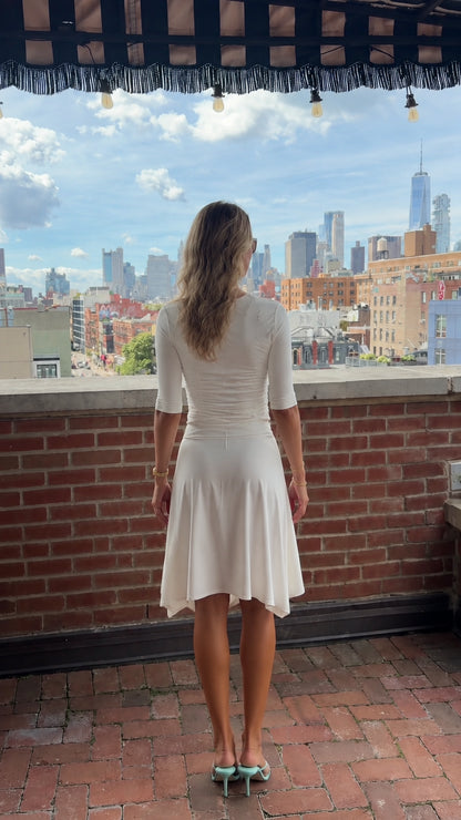 Back view of cream half-sleeve ribbed top and matching flowy skirt