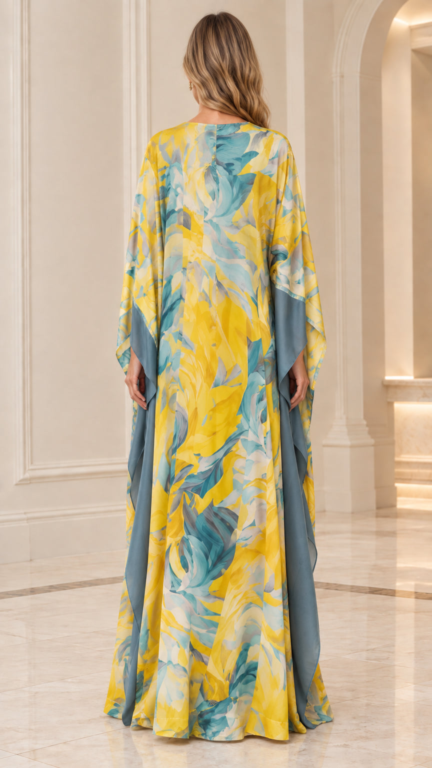 Back view of woman showcasing fluid drape of yellow floral caftan dress
