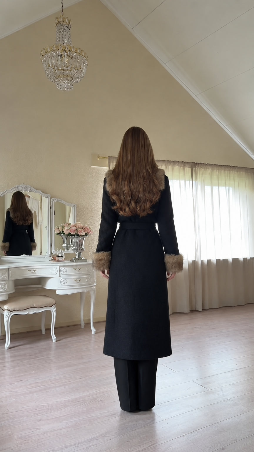 Back view of model wearing tailored Black maxi coat