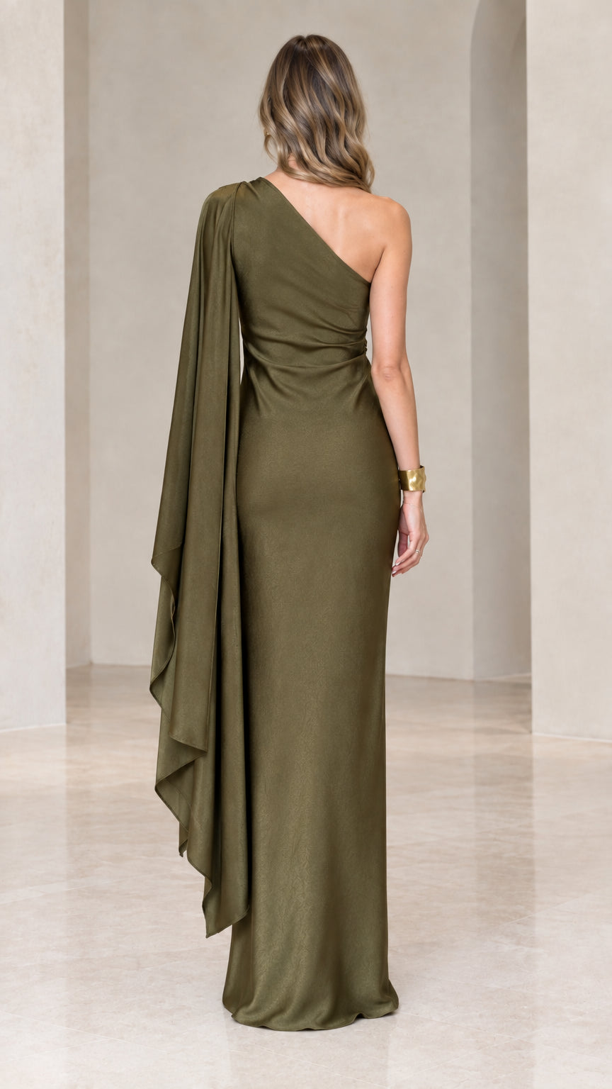 Back view of olive green asymmetrical satin gown with flowing draped sleeve