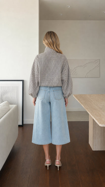 Back view of model wearing white plaid high-neck blouse