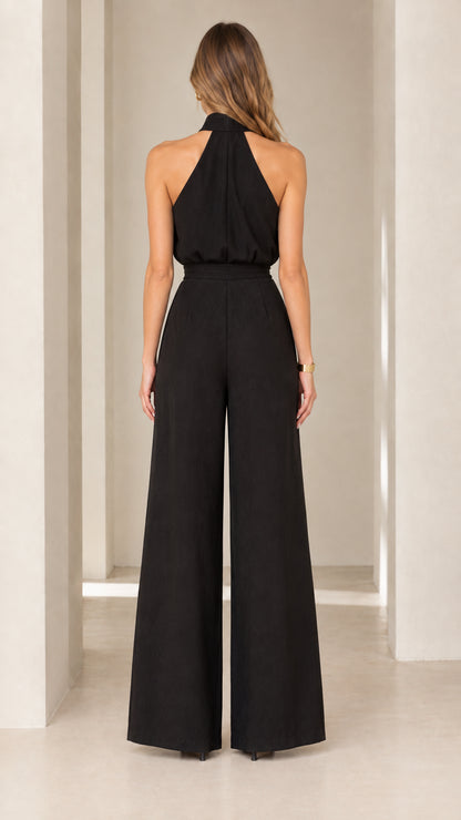 Back view of model wearing black halter neck evening jumpsuit