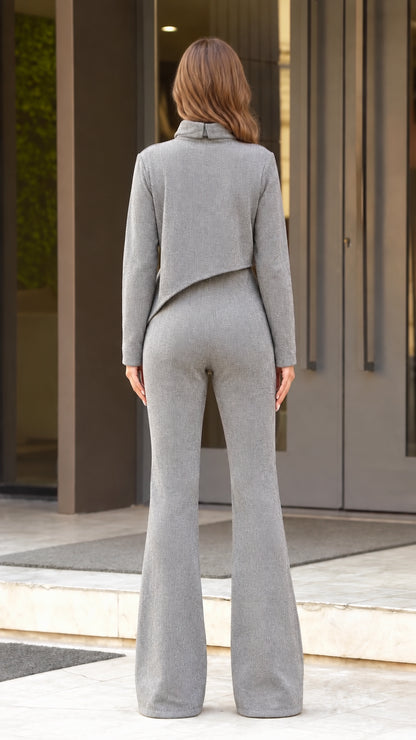 Back view of woman wearing grey mock neck top and high waist flared pants