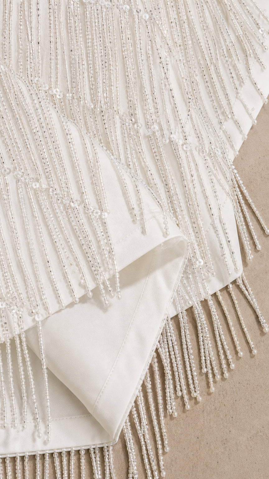 Close-up detail of delicate beaded fringe embellishments and smooth lining