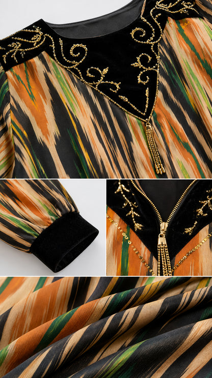 Close-up details of gold-tone embroidery on black velvet neckline and sleeve cuffs