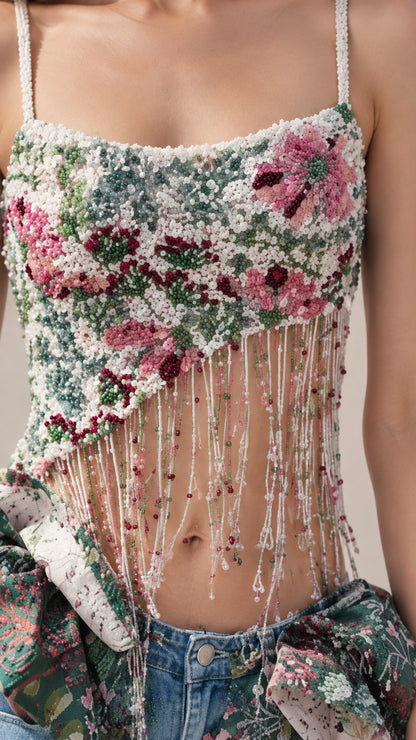 Close-up detail of multi-colored floral beading and hanging bead fringe on cami top