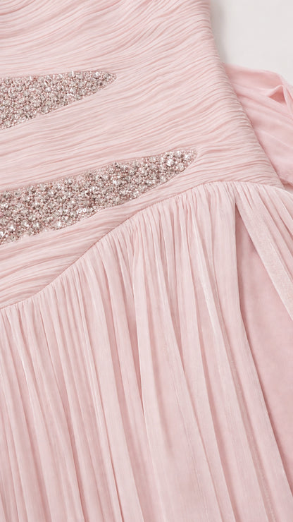 Close-up of crystal embellishment and ruching detail on pink dress