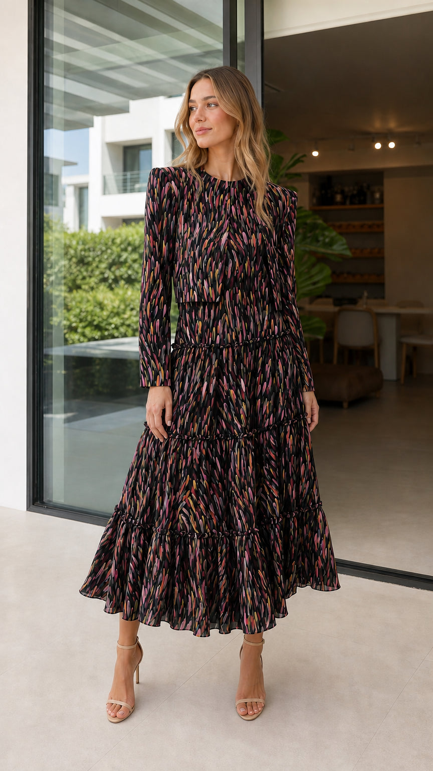 Model wearing black abstract print tiered midi dress