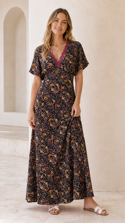 Front view of model wearing black floral lace trim maxi dress