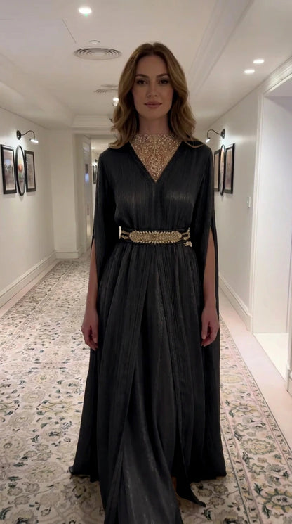 Black pleated cape evening gown with beaded illusion neckline