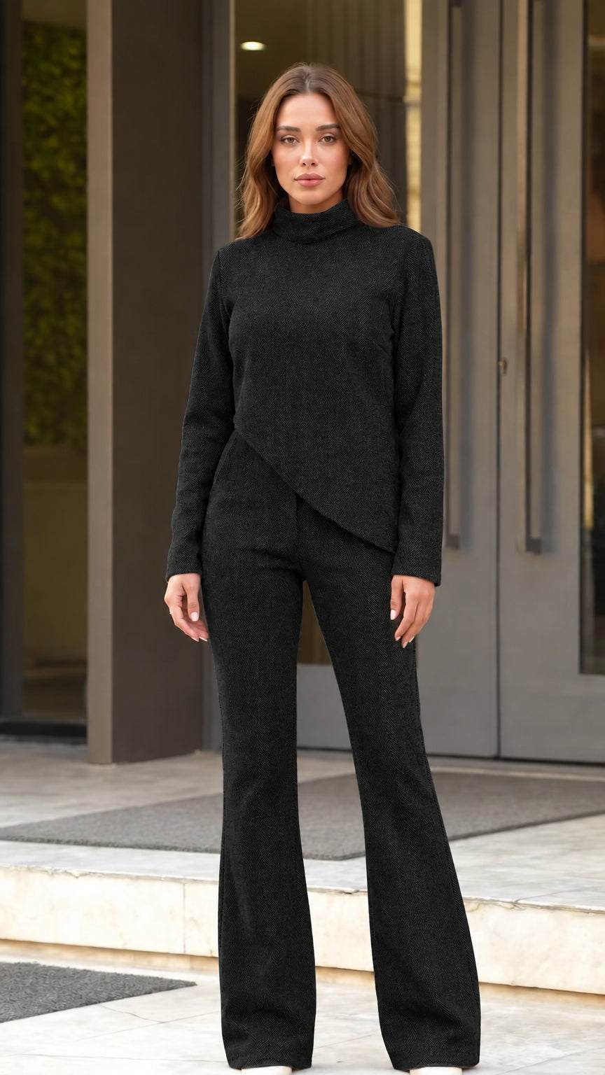 Front full view of woman wearing black asymmetric top and flared pants set