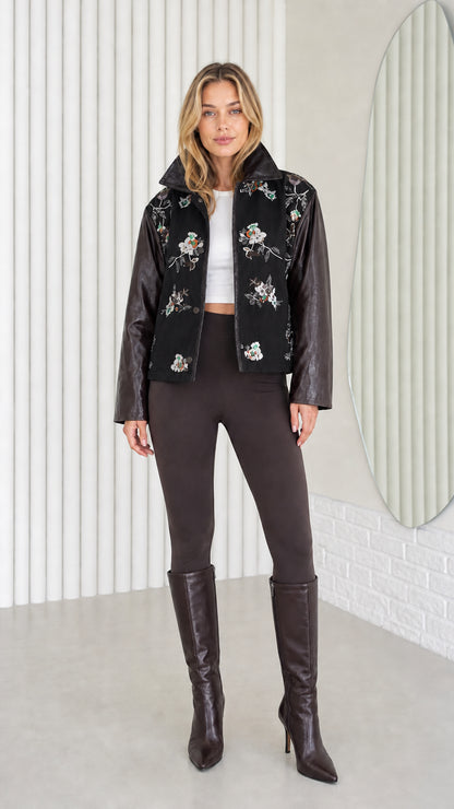 Model wearing Black embroidered jacket with contrast faux leather sleeves