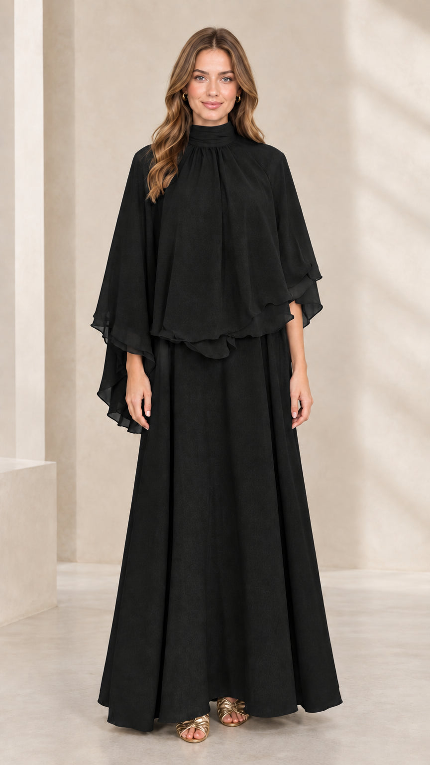 Front view of woman wearing black mock neck capelet maxi dress