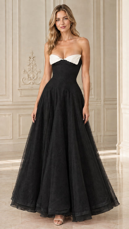 Front view of Black strapless formal gown with white contrast bust trim