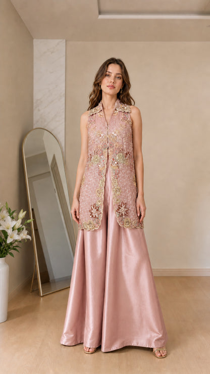 Front view of model wearing dusty pink embroidered vest and satin palazzo set
