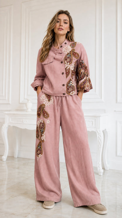 Model wearing dusty pink embroidered beaded jacket and matching wide-leg pants set