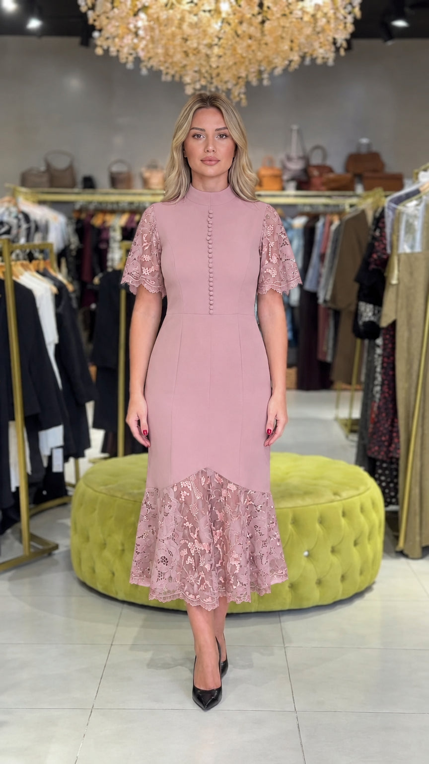 Model wearing dusty pink mock neck midi dress with lace sleeves and flounce hem