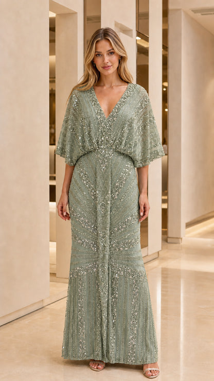 Full length view of woman in sage green beaded formal dress