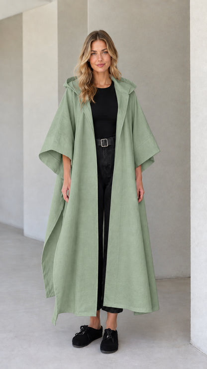 Model wearing sage green hooded maxi canvas cape coat