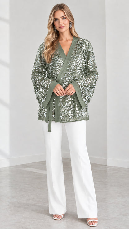 Model wearing Sage Green sequin kimono wrap jacket paired with white wide-leg trousers