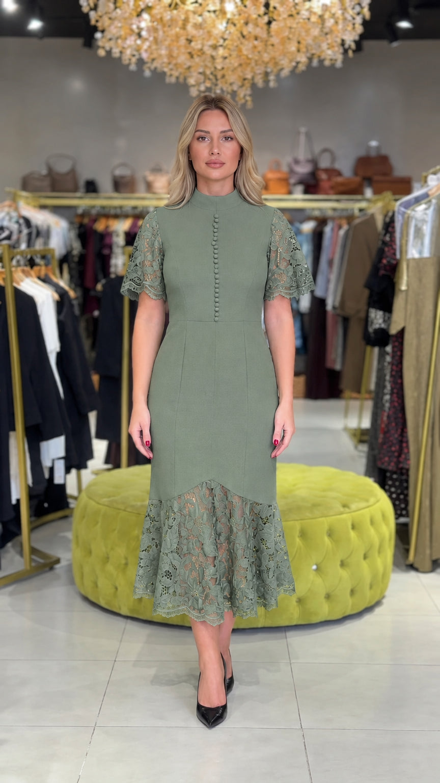 Model wearing sage green mock neck midi dress with floral lace accents