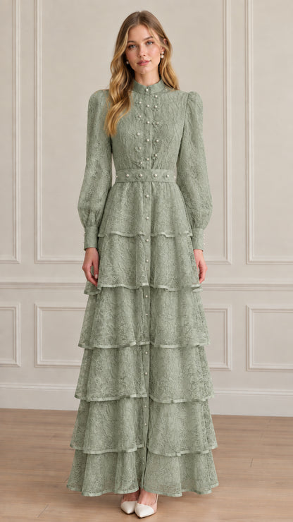 Model wearing sage green tiered lace maxi dress with high neck and pearl details