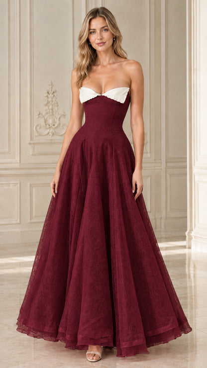 Front view of Burgundy strapless formal ball gown with white contrast bodice trim