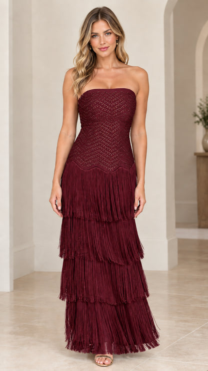 Front view of woman wearing burgundy wine strapless tiered fringe evening dress