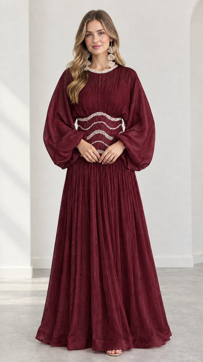 Model wearing burgundy red pleated evening maxi gown