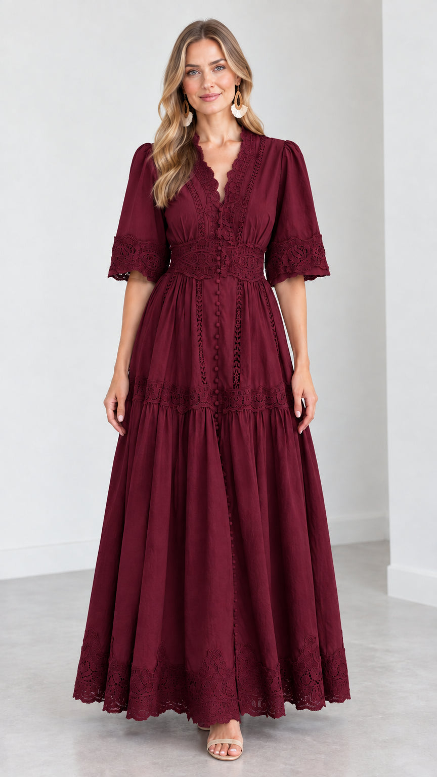 Front view of woman wearing a burgundy wine red V-neck lace trim tiered maxi dress