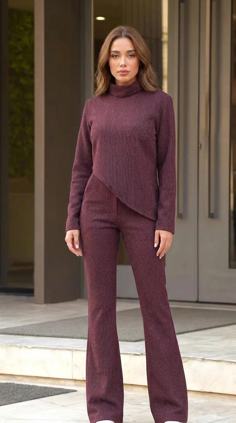 Front full view of woman wearing burgundy asymmetric mock neck pant set
