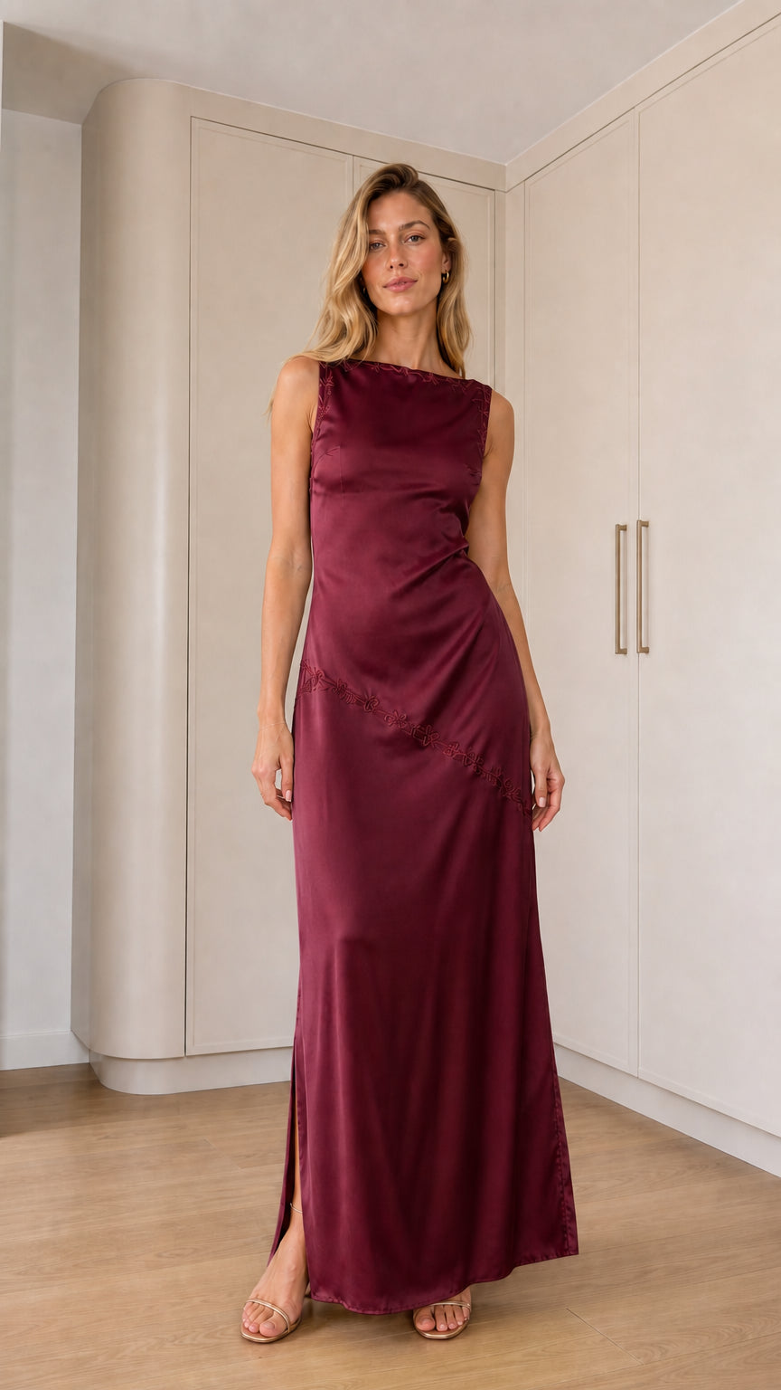 Front full-length view of model wearing burgundy sleeveless satin maxi dress