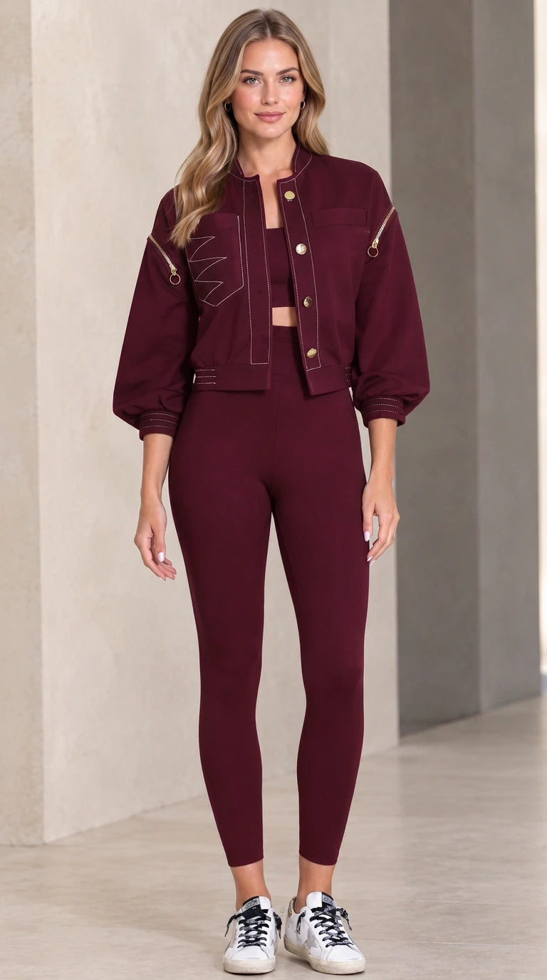 Model wearing burgundy cropped utility jacket paired with sports set