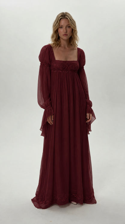 Front view of model wearing burgundy red empire waist chiffon maxi dress