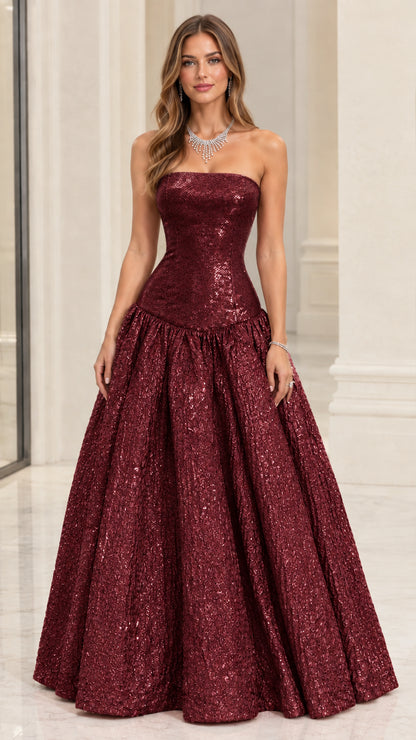 Model wearing Burgundy red strapless metallic drop-waist evening gown