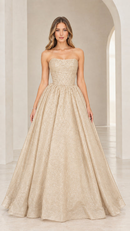 Front view of model in champagne gold strapless shimmering evening gown