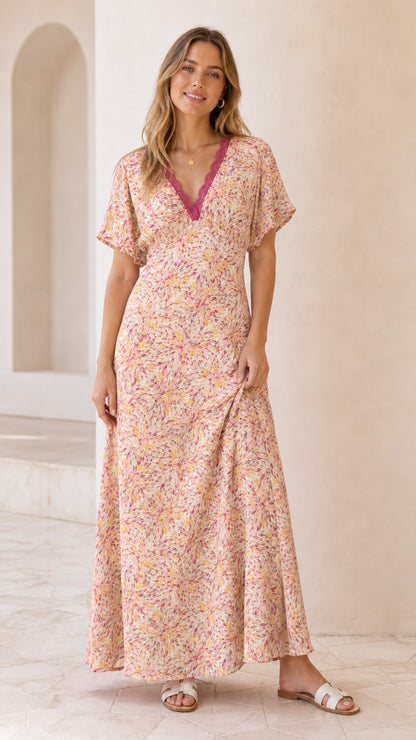 Front view of model wearing blush pink floral lace trim maxi dress
